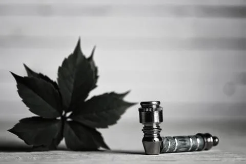 Marijuana pipe on wooden background Stock Photos