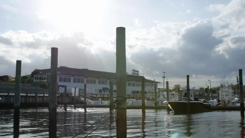 Marina with clouds and low sun making flares in background Stock Footage 107947666
