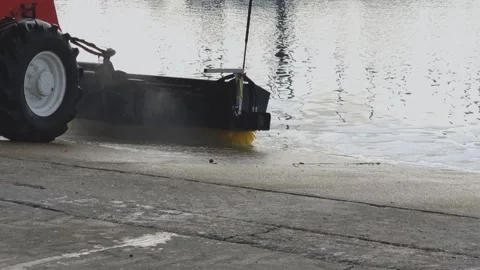 A marina slipway being cleaned with telehandler and hydraulic brush Stock Footage 297879148