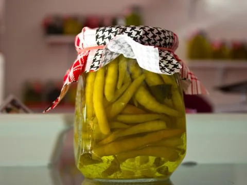 Marinated and pickles vegetables - hot peppers, tomatoes, cucumbers in glass  Stock Photos