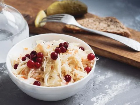Marinated cabbage with cranberries, lightly salted cucumber, black bread and  Stock Photos