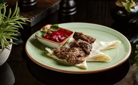 Marinated calf kebab served with flatbreads and pomegranate, onion and herbs Stock Photos