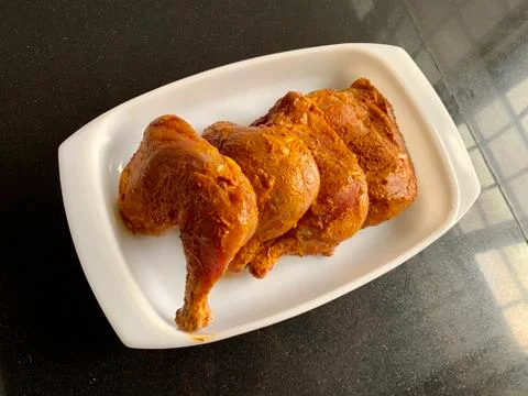 Marinated chicken in a dish Stock Photos