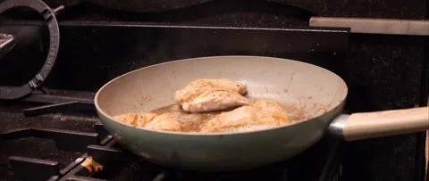 Marinated chicken fillets cooking in pan Stock Footage 321615735