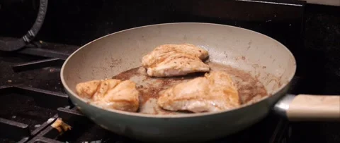 Marinated chicken fillets cooking in pan Stock Footage 321615924