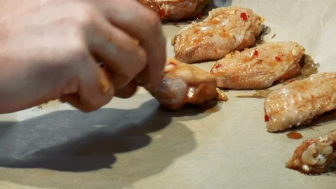 Marinated chicken wings on a baking sheet Stock Footage 86379376