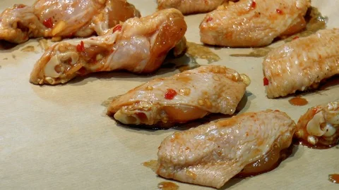 Marinated chicken wings on a baking sheet Stock Footage 86379777