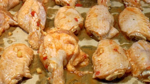 Marinated chicken wings on a baking sheet Stock Footage 86380390