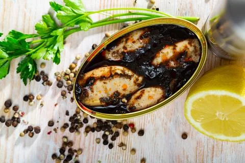 Marinated chipirones in ink with greens and lemon Stock Photos