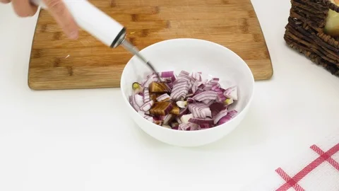 Marinated chopped red onion close up in a bowl on white background.  Stock Footage 126356768
