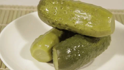 Marinated cucumbers rotating on white background Stock Footage 69947218