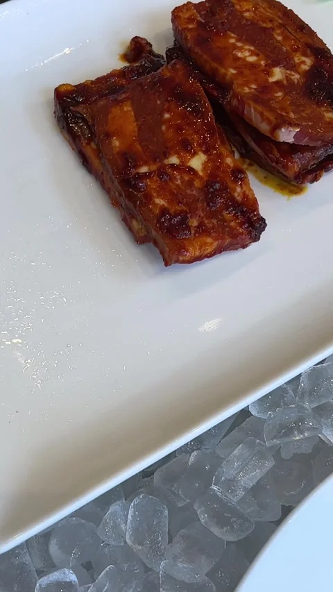 Marinated grilled meat Close up of hand using metal knife to cutting into piece Stock Footage 279651624