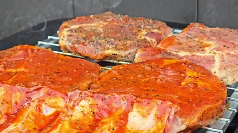 Marinated meat steaks steaming while cooking on grill Stock Footage 344700874
