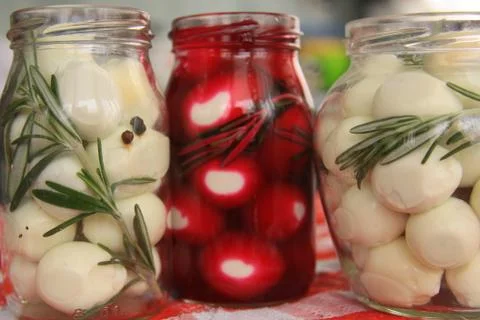 Marinated quail eggs in jars Stock Photos