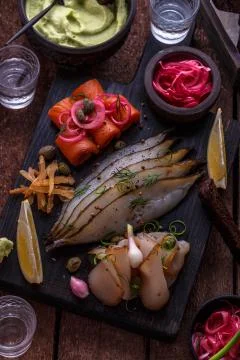 Marinated salmon, cod and halibut with vodka. Stock Photos