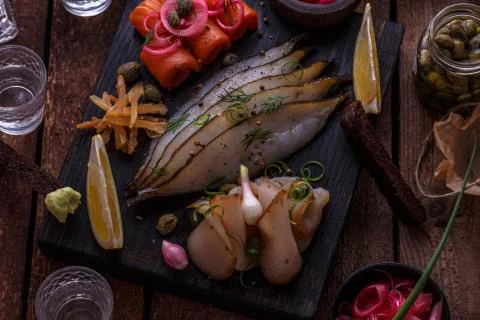 Marinated salmon, cod and halibut with vodka. Stock Photos