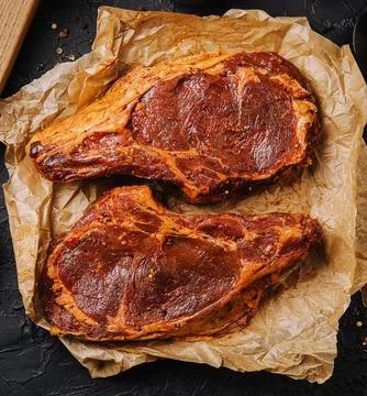 Marinated t bone beef steak top view Stock Photos