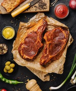 Marinated t bone beef steak top view Stock Photos