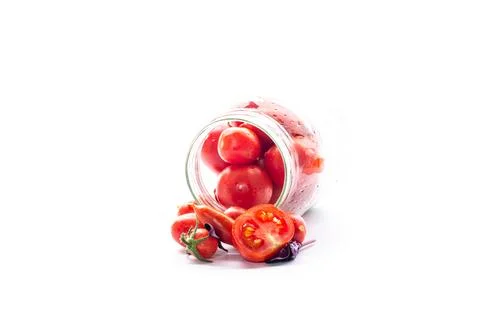 Marinated tomatoes in jars on a white background for winter storage Stock Photos