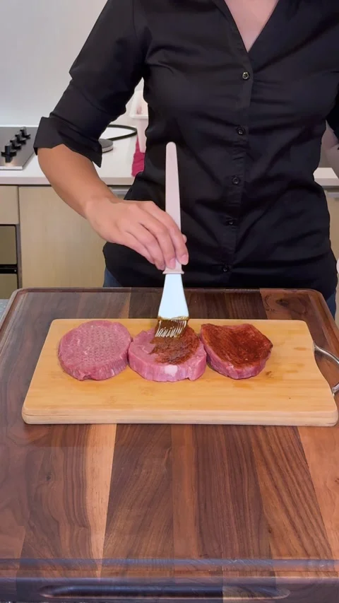 Marinating Beef Steaks with BBQ Sauce Using Brush, Raw Meat Preparation Stock Footage 331075308