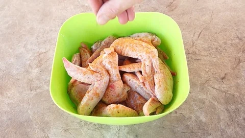Marinating chicken. Hands marinate chicken. Chicken wings. Chicken meat Stock Footage 89898481