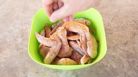 Marinating chicken. Hands marinate chicken. Chicken wings. Chicken meat Stock Footage 89898485