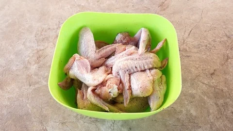 Marinating chicken. Hands marinate chicken. Chicken wings. Chicken meat Stock Footage 89929648