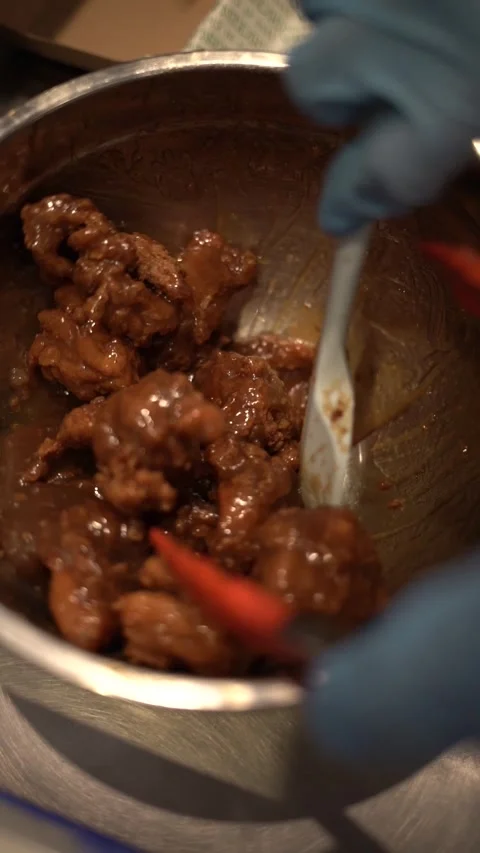 Marinating chicken slices with a thick hot spicy sauce for fried chicken. Stock Footage 304769279