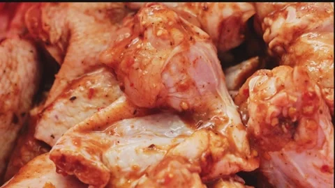 Marinating chicken wings in red tomato sauce with spicy spices are prepared for Stock-Footage 247176888