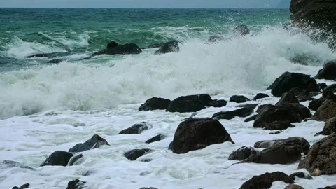 Marine background. Turquoise Storm waves roll on the shore and break into foam o Stock Footage 238988043