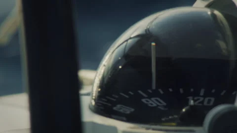 Marine compass close up with dynamic water rushing past in the background - Stock Footage 340396645