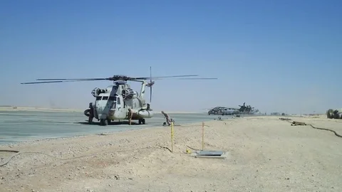 Marine crew loading chopper Stock Footage 70429003