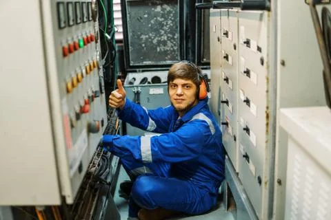 Marine engineer inspecting ship's engine or generators Stock Photos