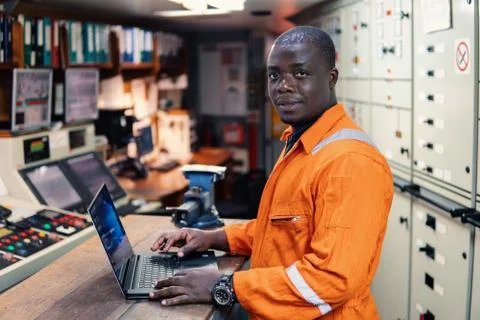 Marine engineer officer working in engine room Foto stock