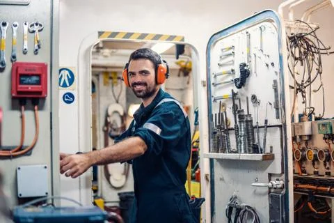 Marine engineer officer working in engine room Foto stock