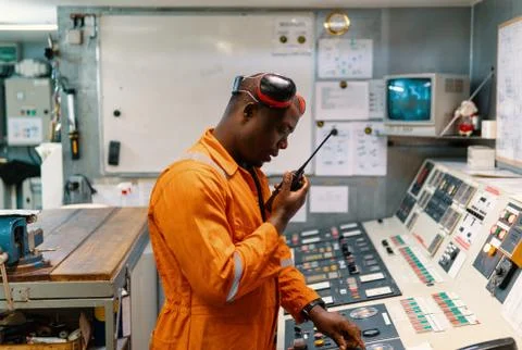 Marine engineer officer working in engine room Stock Photos