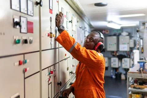 Marine engineer officer working in engine room Stock Photos