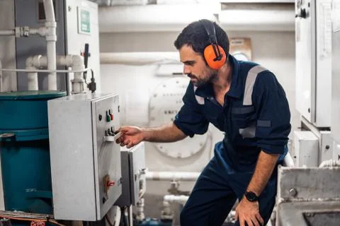 Marine engineer officer working in engine room Stock Photos