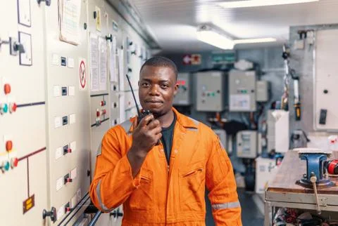 Marine engineer officer working in engine room Stock Photos