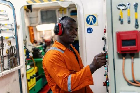 Marine engineer officer working in engine room Stock Photos