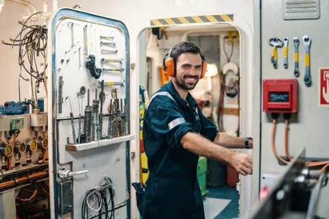 Marine engineer officer working in engine room Stock Photos