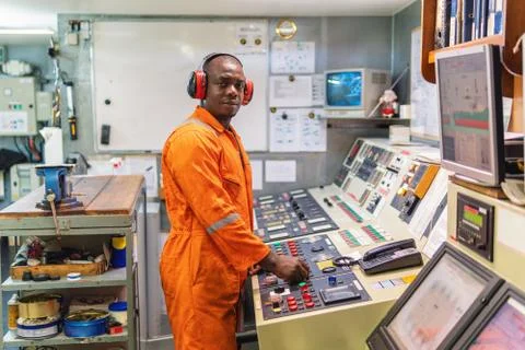 Marine engineer officer working in engine room Stock Photos