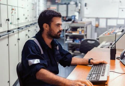 Marine engineer officer working in engine room Stock Photos