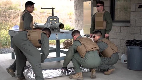 Marine EOD technicians wrapping MK22 Mod 4 rocket motor in silver foil Stock Footage 111257217