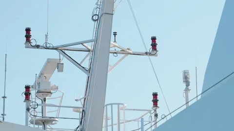 Marine navigation lights and communication antennas on white ship mast structure Stock Footage 342048496