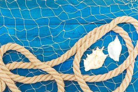 Marine network rope and shells on blue disks Fotos Stock
