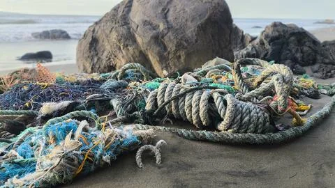 Marine Plastic Pollution Ghost Nets and Ropes Washed Ashore on Beach Stock Photos
