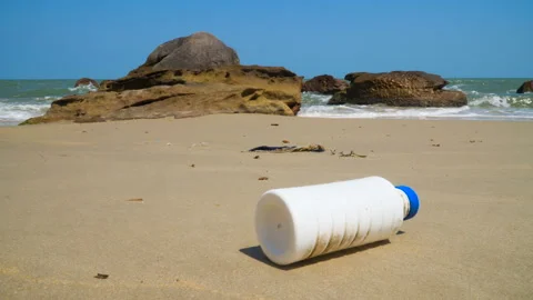 Marine pollution, a plastic bottle on a ocean shore. Environmental problem. Stock Footage 106625500