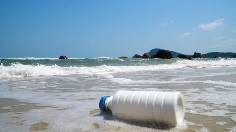 Marine pollution, a plastic bottle on a ocean shore. Litter on contaminated Stock Footage 107048047