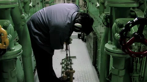 Marine Technician Checking Engine Oil Inside Tugboat Engine Room, 4K Stock Footage 326922449